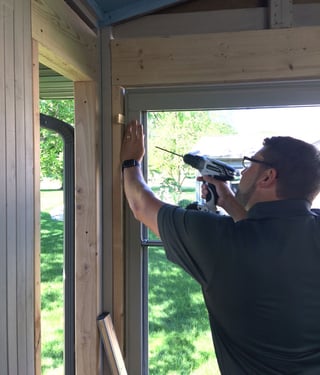 Use drill to secure window with screws